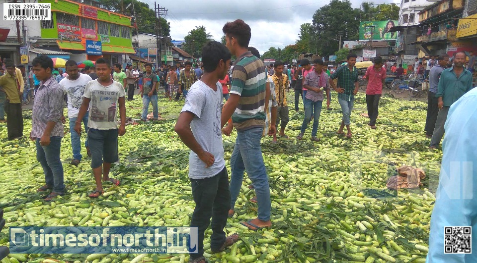 Farmers Block Road by Spreading Cucumbers at Dhupguri in Protest of Less Price